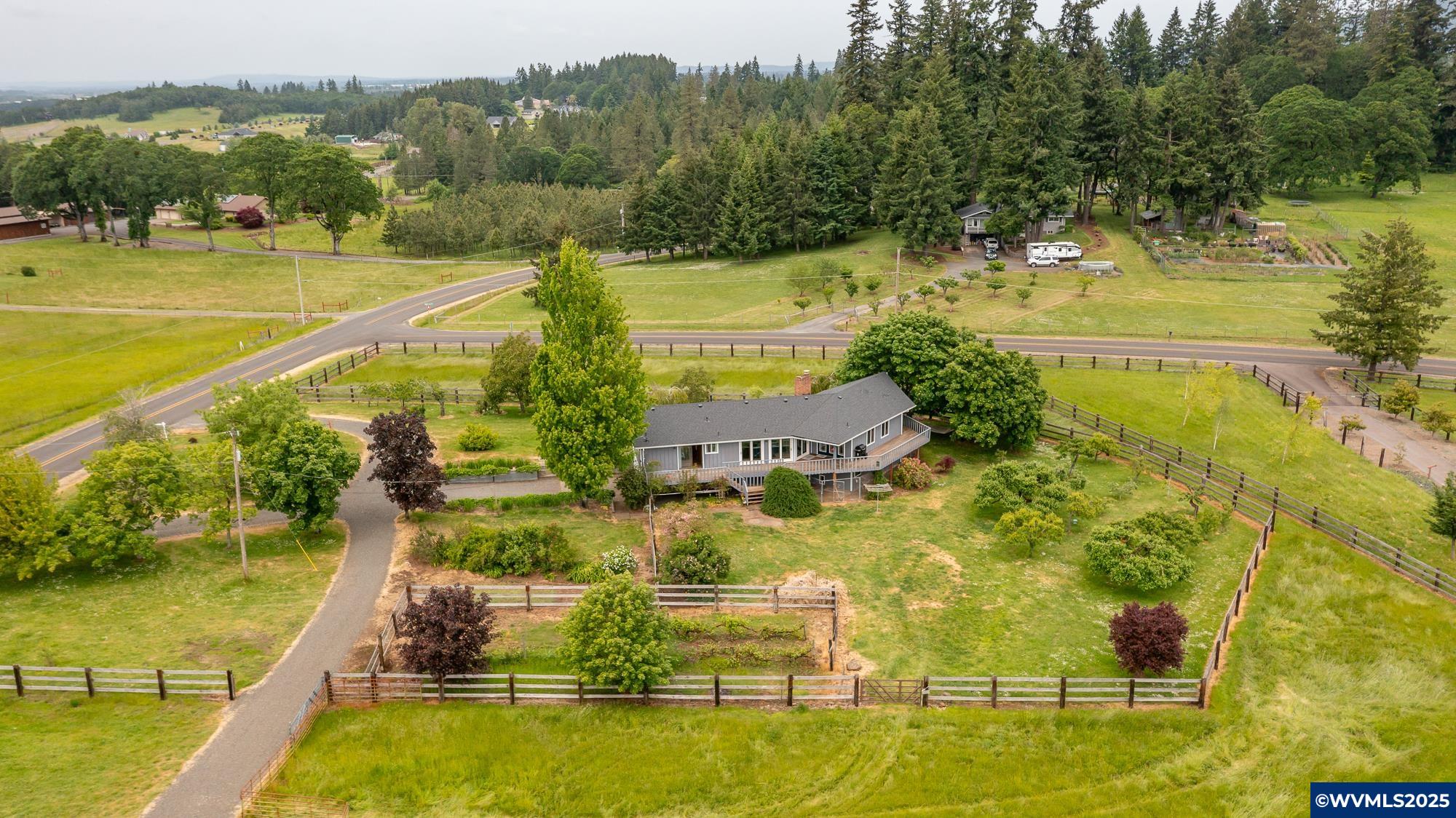Nestled on 4.5 acres of beautiful pastureland, this remodeled home has comfort & charm. Surrounded by fruit trees & sweeping views, the property provides a peaceful retreat while being conveniently close to town. Step inside to find a bright, open floor plan with high-end finishes. The expansive deck is great for entertaining or enjoying your morning coffee. The finished daylight basement offers an opportunity for dual living, perfect for guests, or multi-generational living. This property has it all! This is a great property for horses or a small farm!