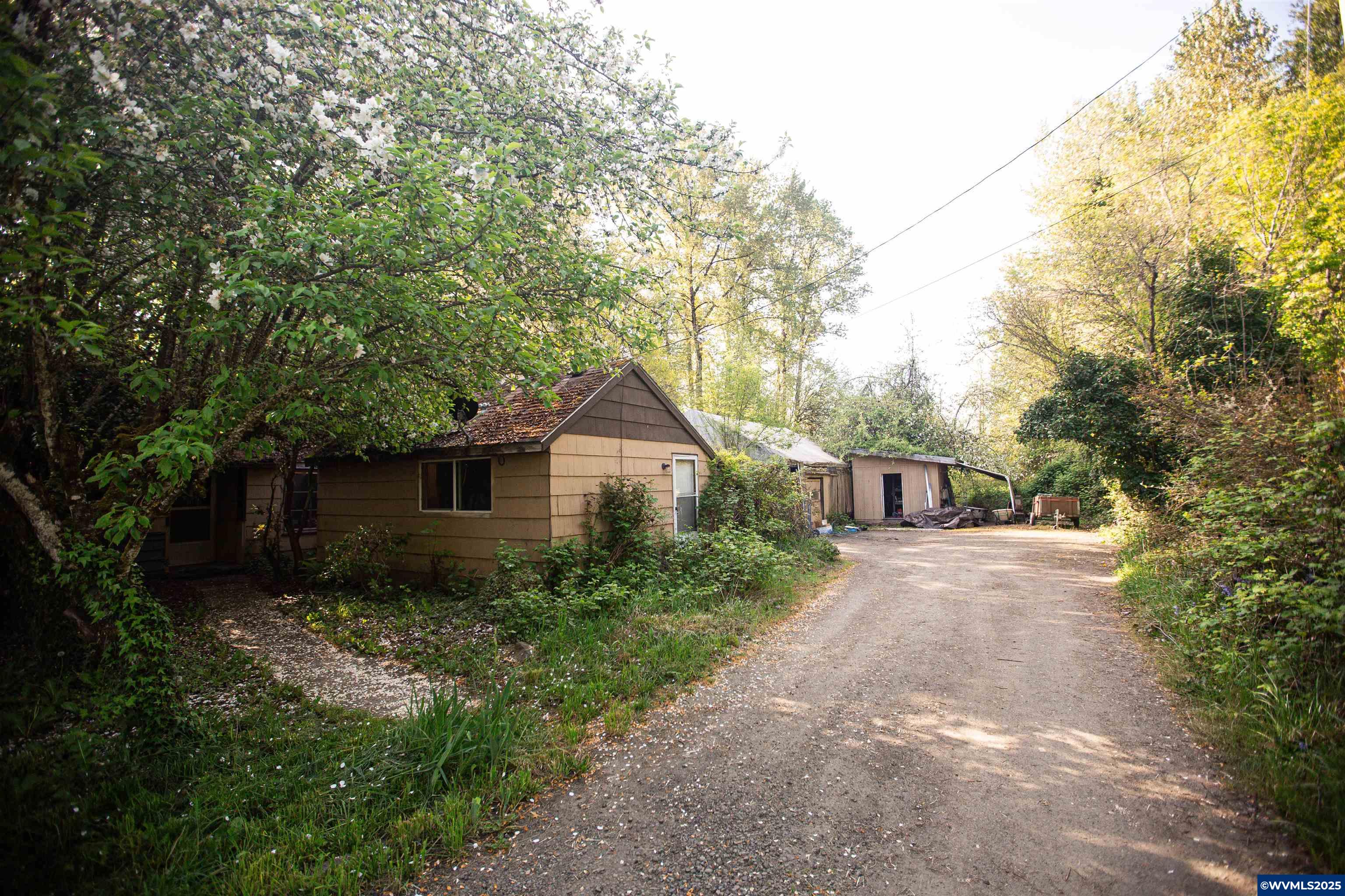 Beautiful tree lined .68 acre lot with rural feel in the center of Corvallis. Zoned Mix Use Employment provides endless possibilities. Existing home makes building easier. House currently has renter in studio apartment providing monthly income. House has no foundation so it has little to no value and will not qualify for lending.