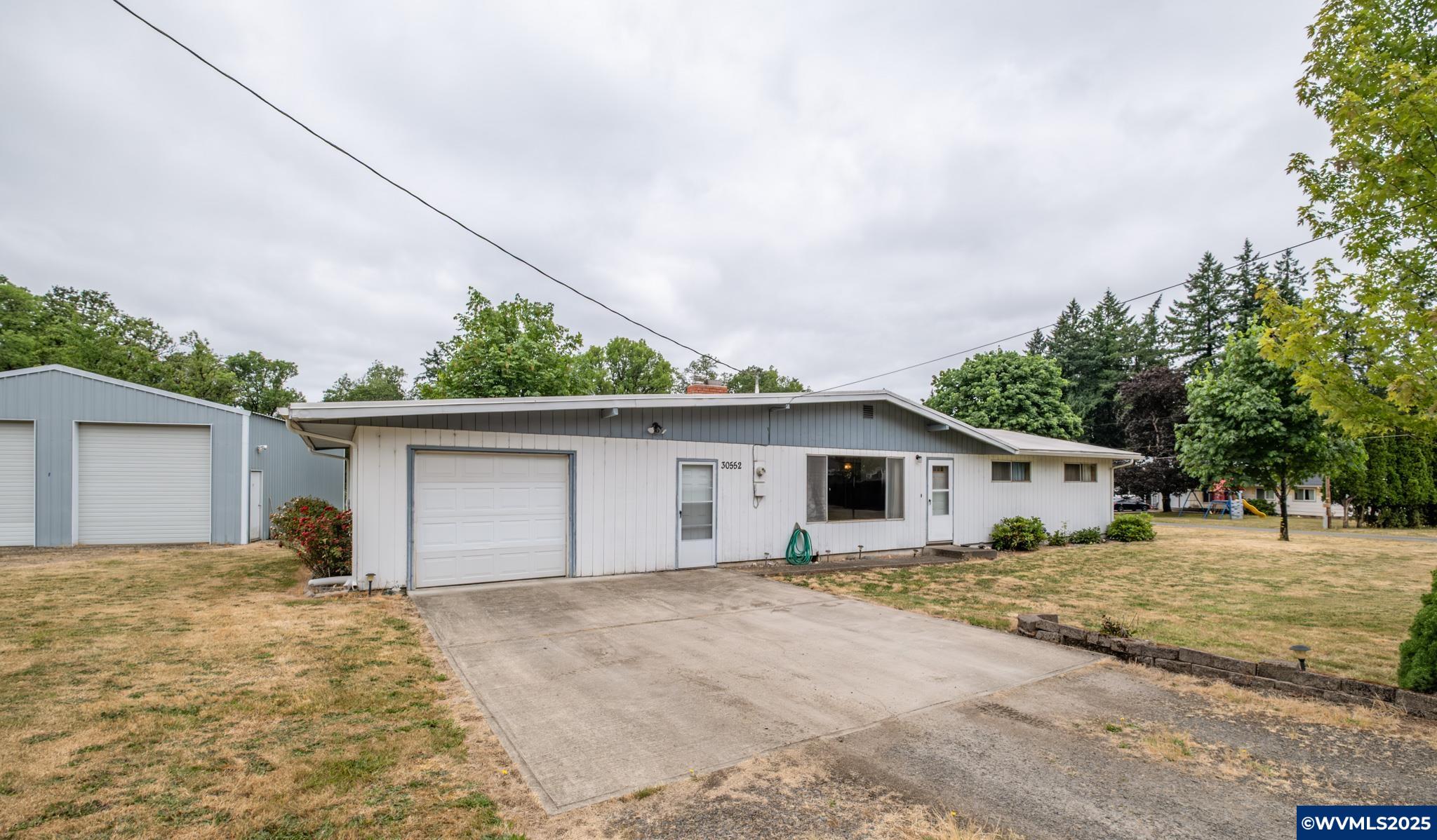 3 bed, 2 bath home offering 1,232 sqft of comfortable living on a serene 1.74-acre lot. Located just minutes from town, this property features a park-like setting with mature trees, a large covered patio ideal for relaxing or entertaining, and a spacious shop perfect for hobbies, storage, or work. Enjoy the peace of country living with the convenience of nearby amenities. A rare find with space, charm, and versatility!