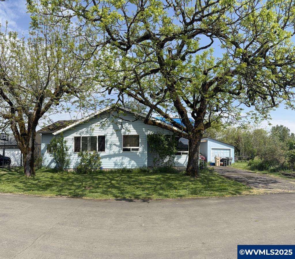 Welcome to your perfect blend of peaceful country living & convenient city access! This charming, Ranch Style home offers a spacious, open-concept layout designed for comfortable living & easy entertaining. Two full bathrooms & generous living spaces, there's plenty of room for everyone to spread out and make this home truly your own. Sitting on a nearly .5 ac, fully fenced, the property provides endless possibilities. Bring your imagination - A detached garage provides extra storage or workshop potential. Bring your imagination - whether you envision a flourishing garden, outdoor entertaining areas, or simply enjoying the wide open space, the canvas is ready for your personal touch. You'll love the added features that make this property stand out. A detached garage provides extra storage or workshop potential, while an outdoor shed comes completed with a riding lawn mower & trailer, making property maintenance a breeze. There's also a dedicated firewood shed, perfect for keeping cozy through the cooler months. Enjoy the freedom and flexibility of a home with no HOA restrictions - store your recreational vehicles, boats or work trailers with ease. A side yard already prepped for gardening awaits your green thumb, and the spacious grounds are ideal for pets, or even future expansions. If you've been dreaming of a peaceful retreat that doesn't sacrifice the conveniences of nearby shopping, dining, and entertainment, this is the opportunity you've been waiting for.. Come see the potential and start imaging your future hear.