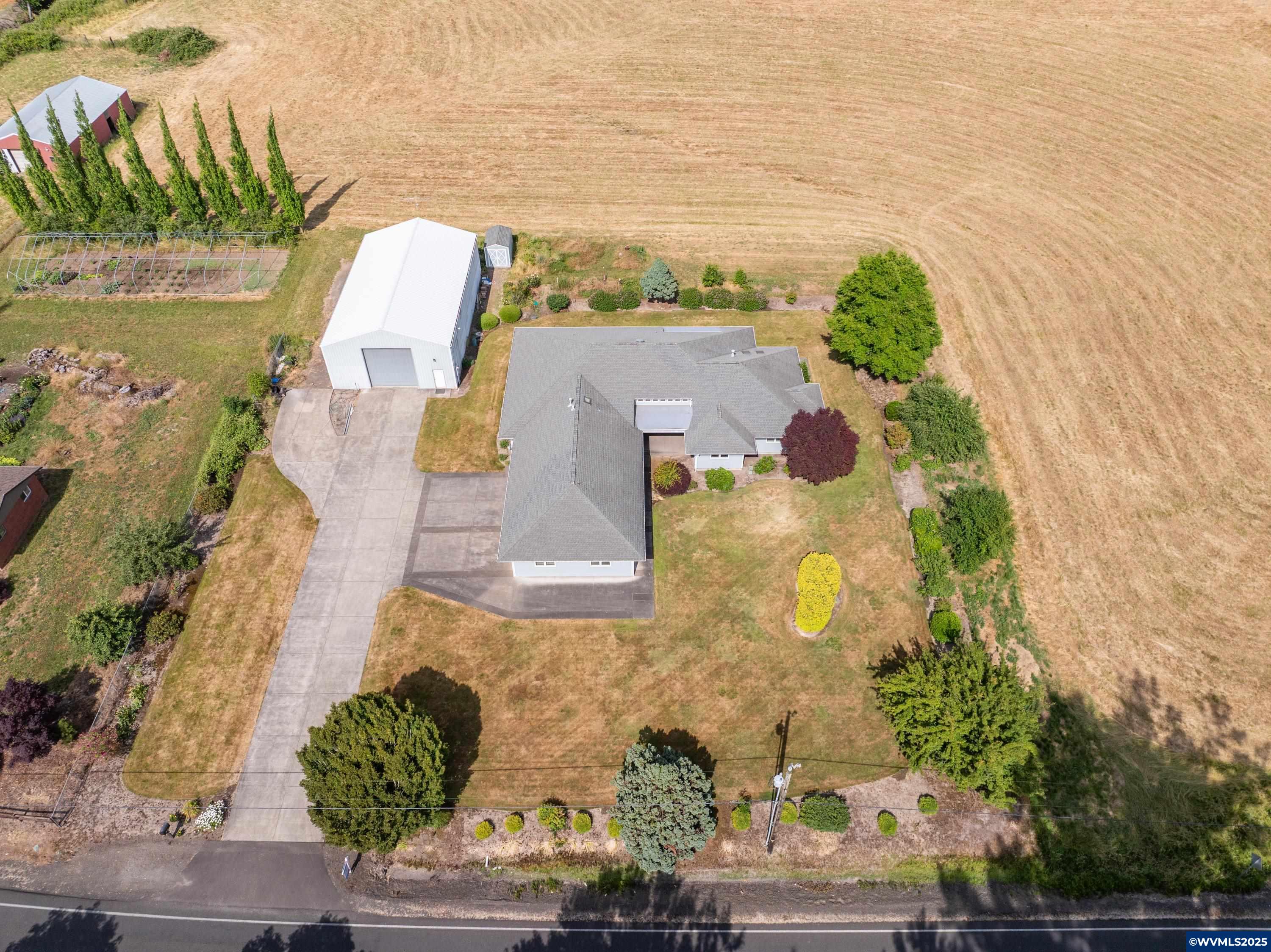 Versatile 16+ acre property w/potential to subdivide with variance (buyer to verify). 3BD/3BA home features dual primary suites—ideal for multi-gen living—plus sep. office w/ext. entry. Large kitchen with two pantries. Includes large shop, barn & mostly level land for ag, animals, or development. Room to grow, live, or invest! The thoughtful layout includes a dedicated home office with its own outside entrance, ideal for remote work or a private client-facing business. Wetland determination underway.