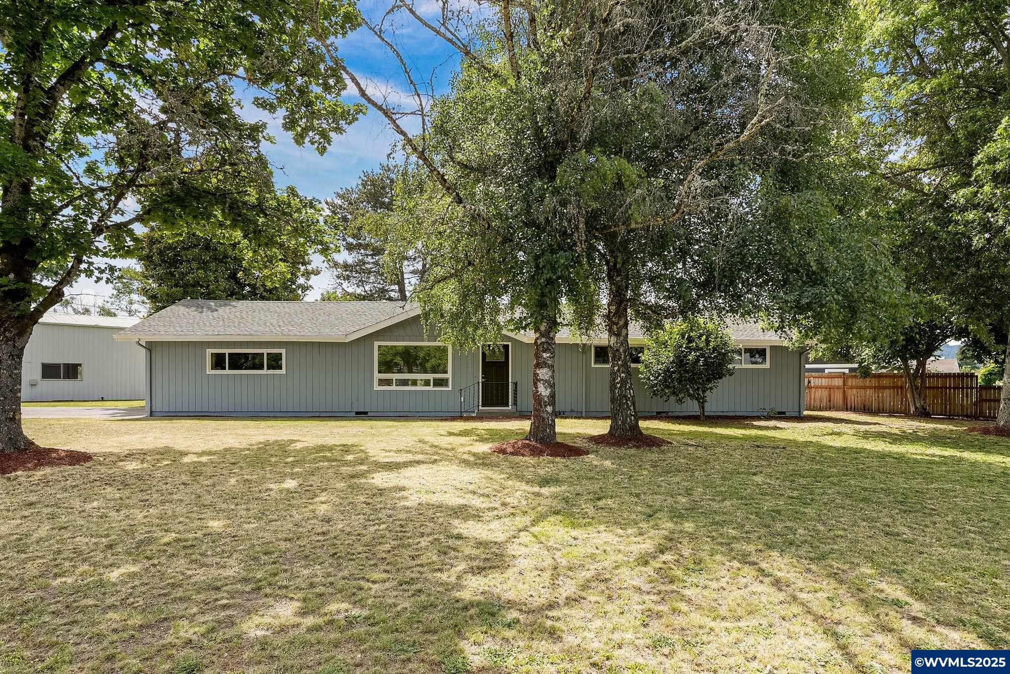 BEAUTIFULLY UPDATED HOME, SPRAWLING LOT, 40x20 SHOP + 20x15 BUILDING. Move in ready home with so many updates & room to spread your wings. 3 large bedrooms + large family/bonus rm (possible 4th bdrm). Gorgeous open kitchen w/ granite counter tops, custom wood cabinets & SS appliances. Fresh int/ext paint, new laminate flooring, doors, lighting, newer roof. Step outside to a covered patio, mature trees, yard space & extra parking! 2 nice outbuildings: 40x20 Shop & 20x15 multi-purpose building. A MUST SEE!