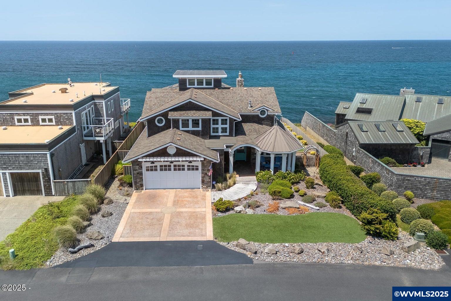 Experience the epitome of Oregon Coast luxury living with this stunning oceanfront masterpiece! No expense spared on this beautiful and impeccably designed 3 Bedroom/4 Bathroom home located on the South Point of Depoe Bay! This craftsman masterpiece was custom built in 2017 for storm watching from atop a high basalt rock shelf to eliminate fear of erosion, with commanding views of a small working harbor and two buoys that lead out to sea. Featuring high-end finishes throughout including custom cabinets, quartz countertops, Thermador appliances, one of a kind primary suite w/ volcanic limestone freestanding tub, Tiled shower w/ 18" showerhead, 2 wall showers and 3 body spray heads, huge walk-in closet, 2nd bedroom w/ ensuite, Hickory hardwood floors, multiple gas fireplaces, shiplap walls, professionally designed & low maintenance yard w/ artificial turf, sprinkler system, sunroom w/ radiant heat floors, family/recreation room, crows nest w/ 360 degree views, two washer/dryers, central vacuum system,Tesla Wall Charger, 8 camera security system, large office, 12 motorized blinds in great room & much more!  Sandy beaches are less than ten minutes away. Depoe Bay is a quaint small town, known as the whale watching capital of Oregon with a small fleet of whale watching and charter fishing boats all within walking distance. Offering a variety of excellent family dining options in addition to many more dining options nearby and located about 15 min from both Lincoln City & Newport. On calmer days you will find a resident pod of gray whales, orcas, sea lions, seals, pelicans, eagles and seagulls. This is your chance to own one of the coast's finest and most one of a kind properties!