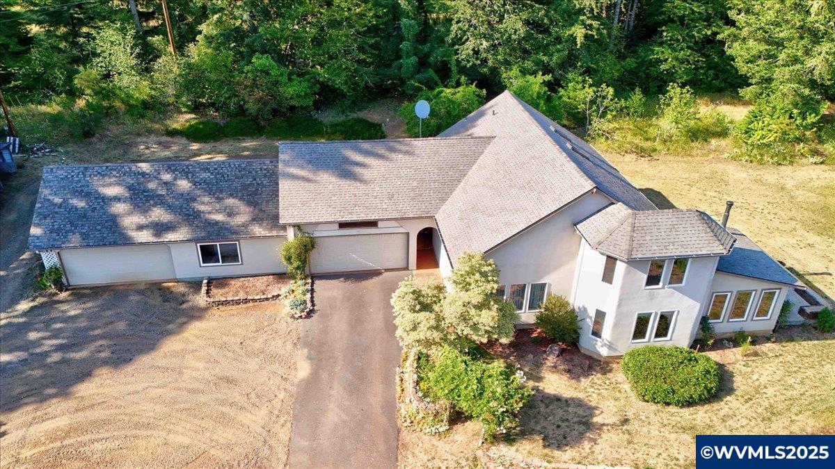 Exceptional Country Living! Thoughtfully designed, it features 3 bedrooms and 2 bathrooms, including a private primary suite, dedicated library ideal for work or relaxation, fully equipped kitchen opens to a dining area and sunroom with a cozy wood-burning stove—perfect for year-round comfort. A separate laundry room adds convenience, while the attached two-car garage, oversized shop, pump house, and multiple sheds offer plenty of space for hobbies.