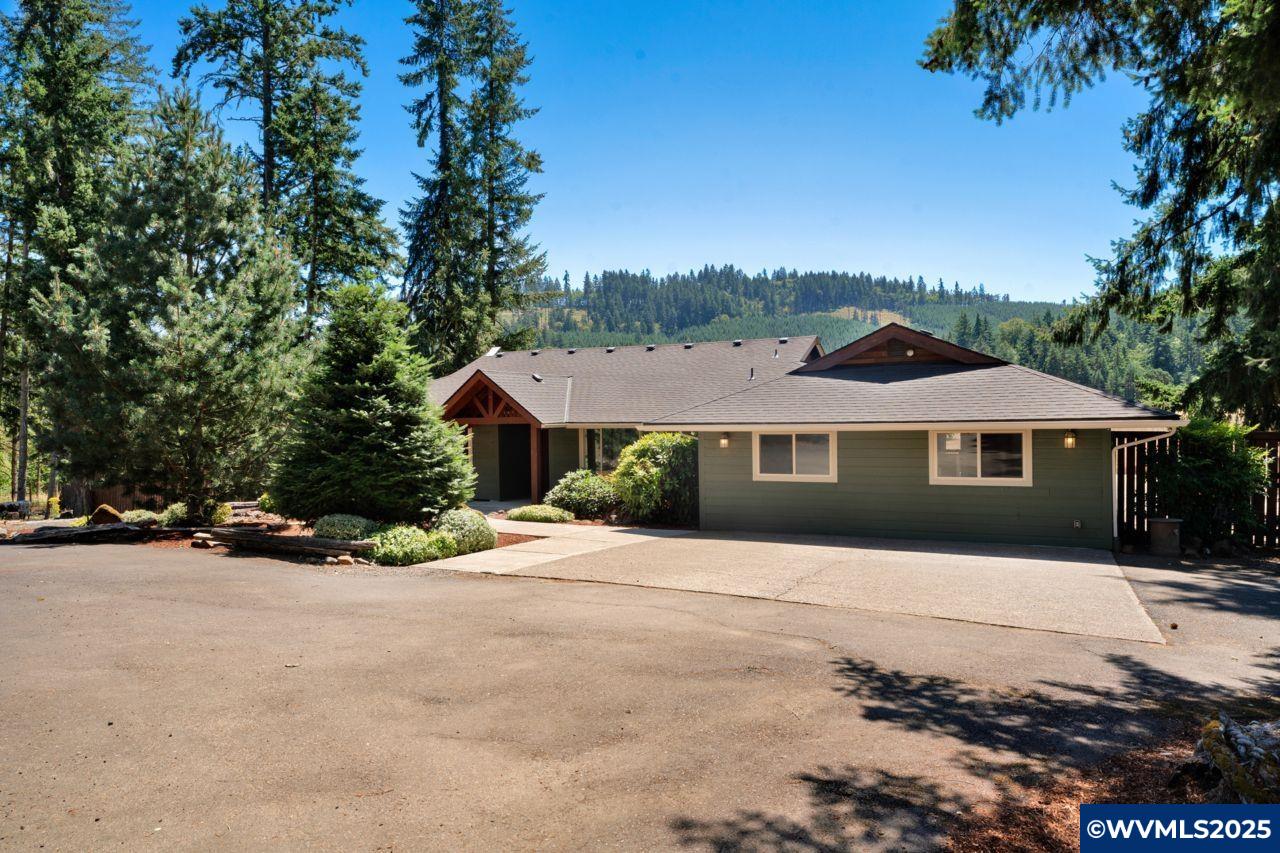 Tucked into 3.5 acres of Oregon countryside, this home offers the best of rural life and nature with towering Douglas firs, open pasture, and sweeping views of McDonald Forest, 35+ miles of hiking trails at your doorstep. Wrap-around covered deck & hot tub for outdoor entertaining. 2022 kitchen remodel with modern finishes & under-cabinet lighting, vaulted ceilings, A/C & new carpet. Expansive RV-sized shop with entertainment or hobby room for projects & large gatherings, all just 15 minutes from Corvallis.