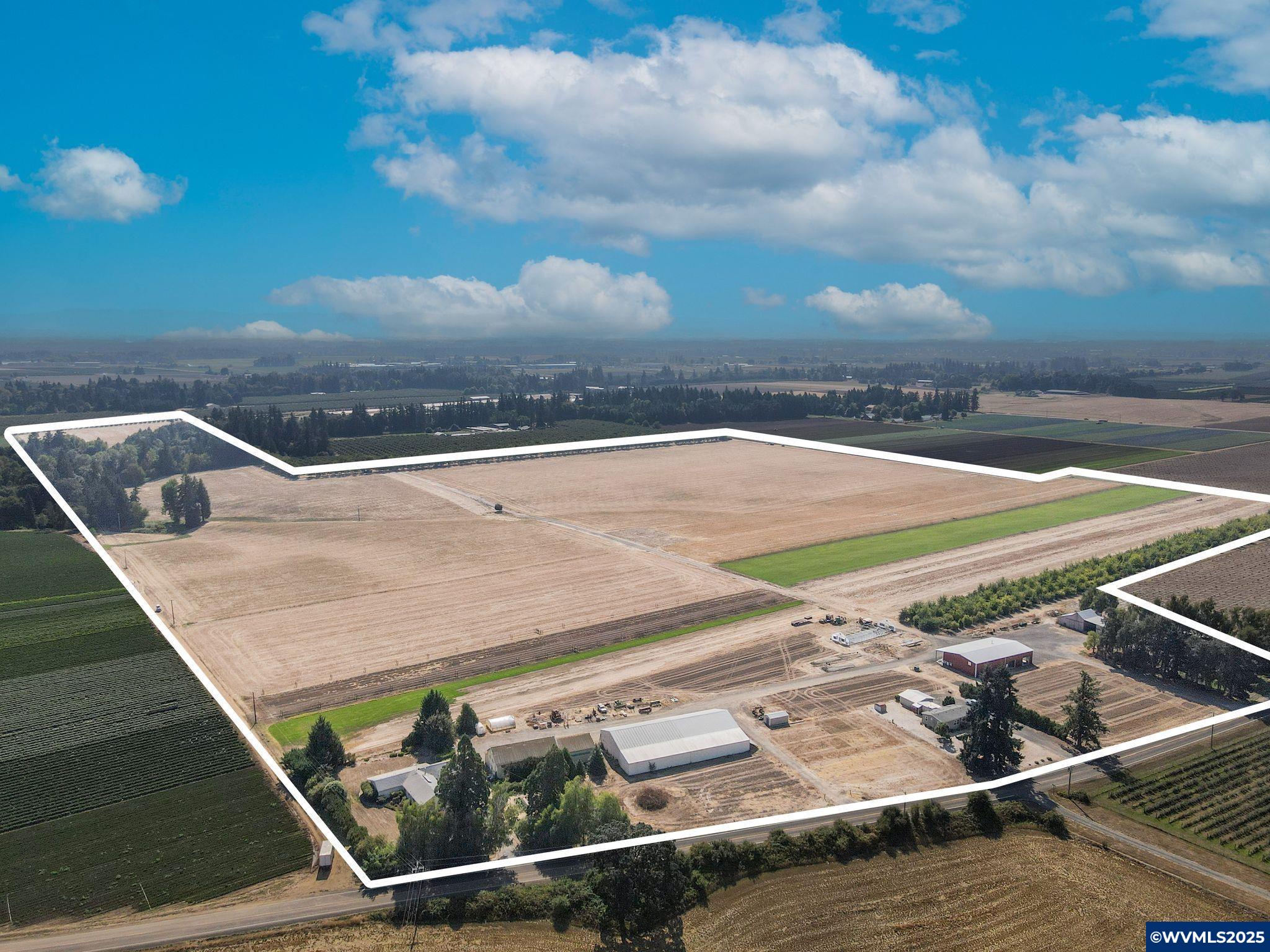 Premier agricultural opportunity! 126 acres, 115 tillable in active grass seed and sod production. Highly productive Woodburn/Amity Silt Loam soils suitable for Hazelnuts or many Willamette Valley crops. Established wtr rights from 1956 and 1944. 50 H.P. pump/400 gpm. 3 large Ag buildings including a 5000 sqft metal bld with 480 volt, 400 amp service. Solar panel system. Greenhouses. 3 HOMES!