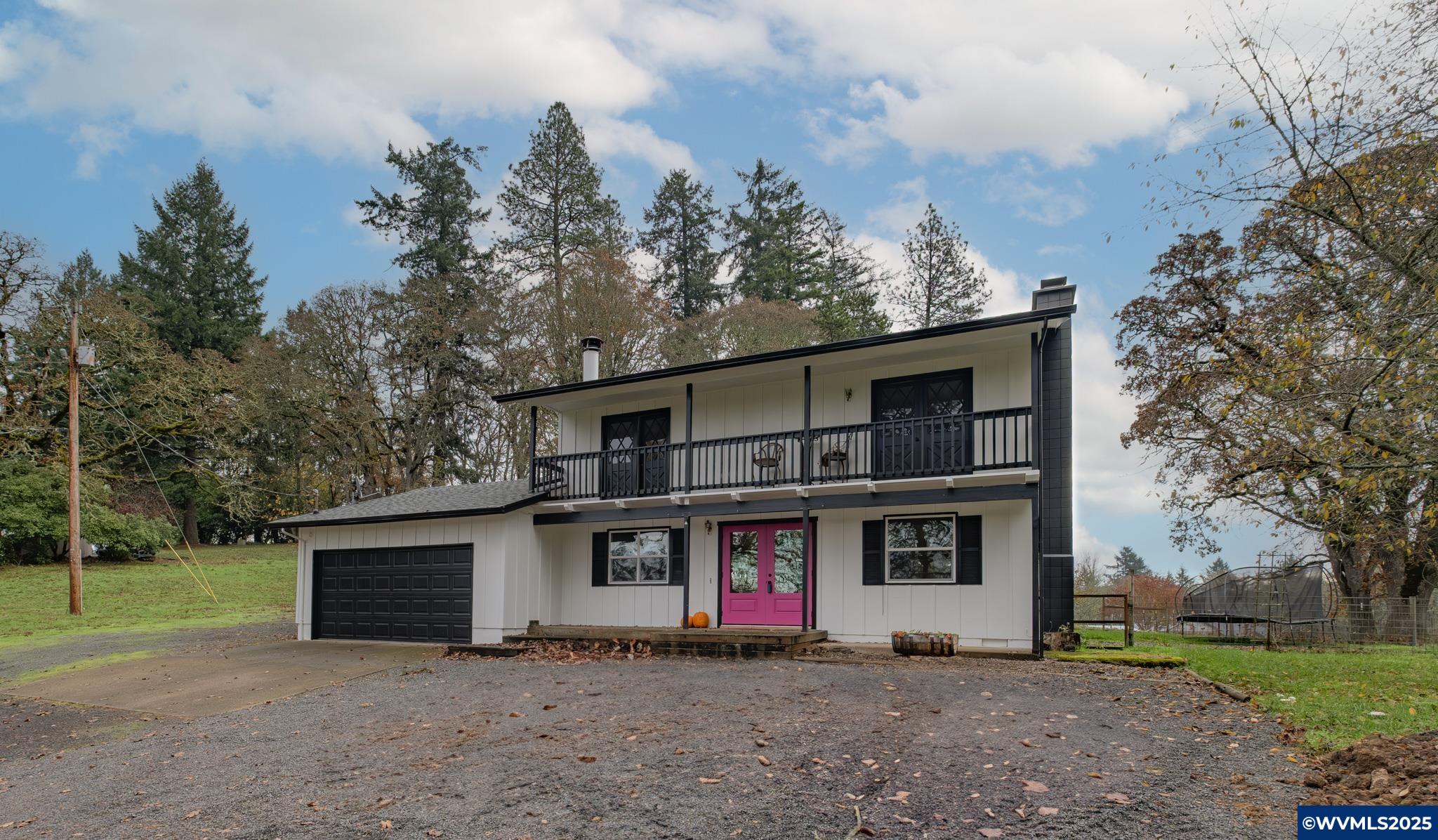 Where Country Comfort Meets Fun Personality!Charming 3 bed, 2.5 bath home on 2.11 acres with bright pink French doors, soaring oak trees, and a cozy covered porch perfect for morning coffee. Updated throughout with quartz counters, new flooring, windows, furnace & AC. Features a private upper deck off bedrooms, fenced area for animals, spacious garage, and peaceful setting close to town. Modern upgrades, big character, and plenty of room to enjoy true country living!