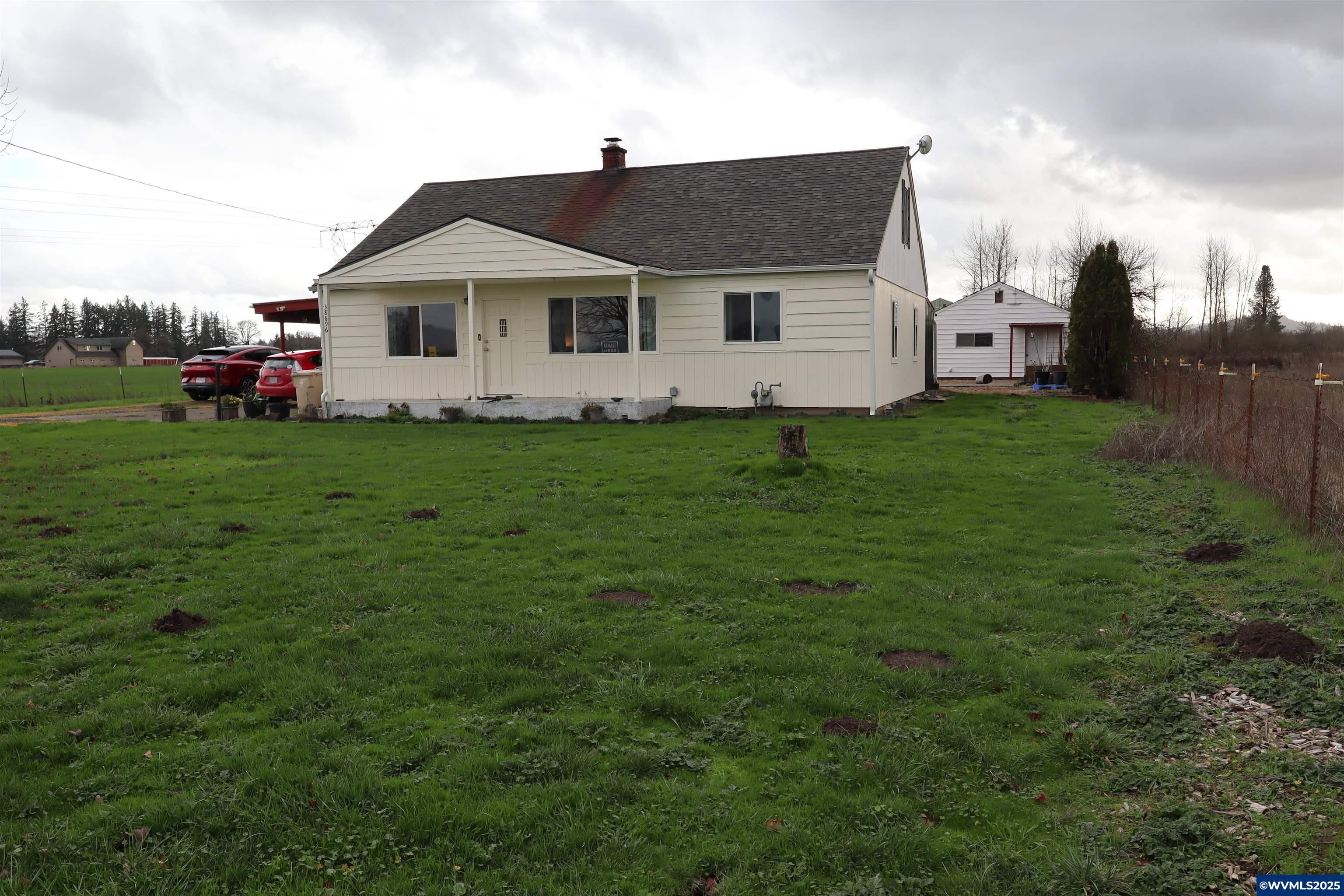 Own your own farm in the mid valley. Endless possibilities. New roof in 2020 on this 2 story cottage. Wood floors and peninsula kitchen with stainless appliances. Large living room heated by wood stove. Detached garage has shop space and separate entrance to a large laundry room. Barn has loft hay storage, Stansion and stall for your critters. Separate lean too off barn and garage for additional storage. Almost 15 acres fenced and cross fenced and seasonal pond. Unbelievable sunsets and opportunities